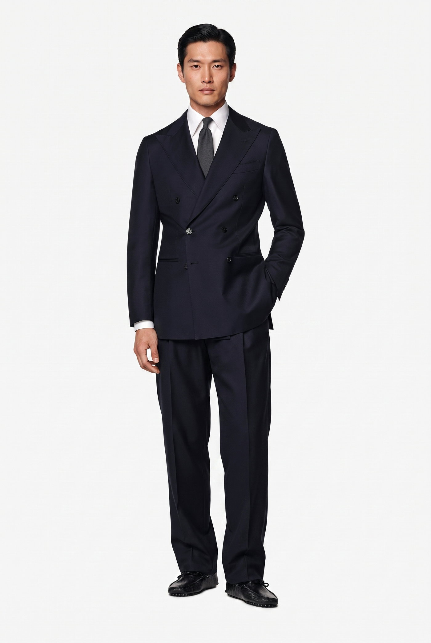 Man in a navy double breasted suit with a white shirt and dark tie