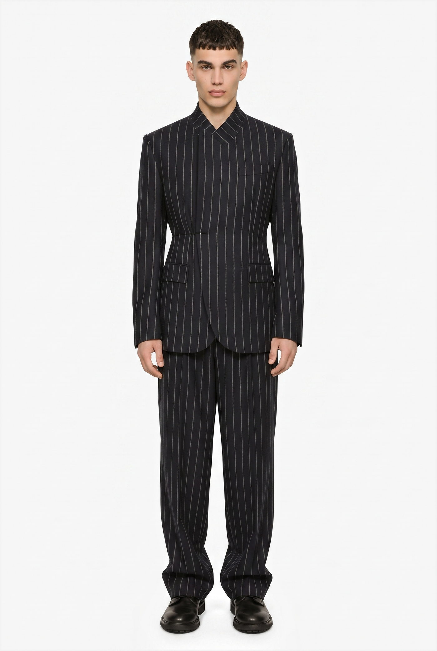 Man in a black pinstripe suit with a fitted waist