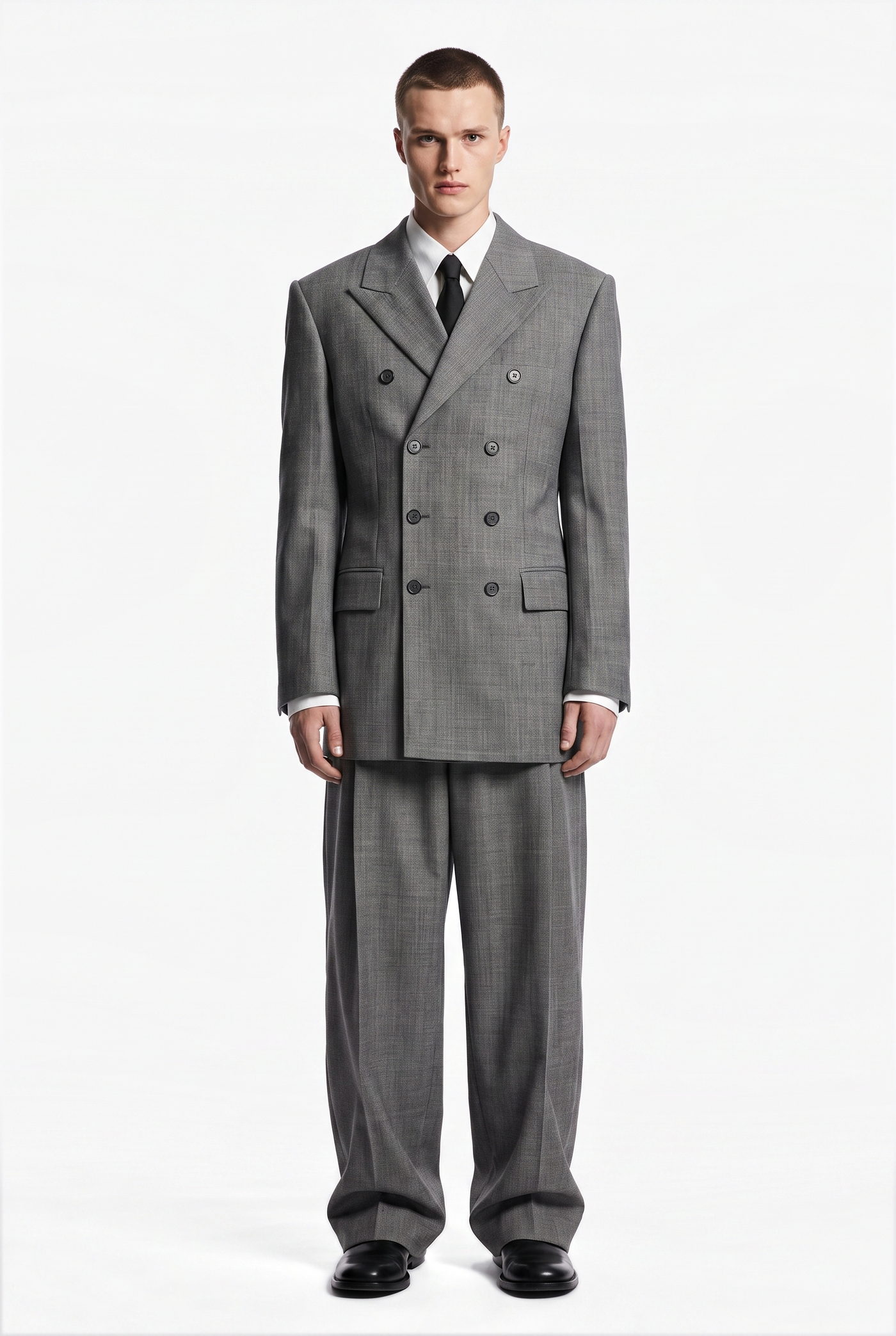 Man in a grey double breasted suit with a dark tie