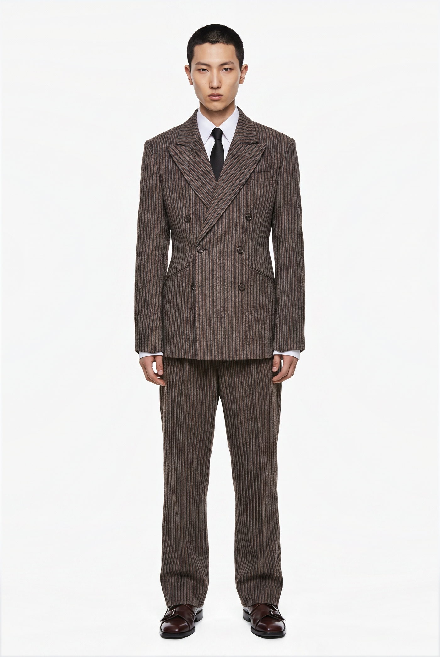 Man in a brown pinstripe double breasted suit with a dark tie