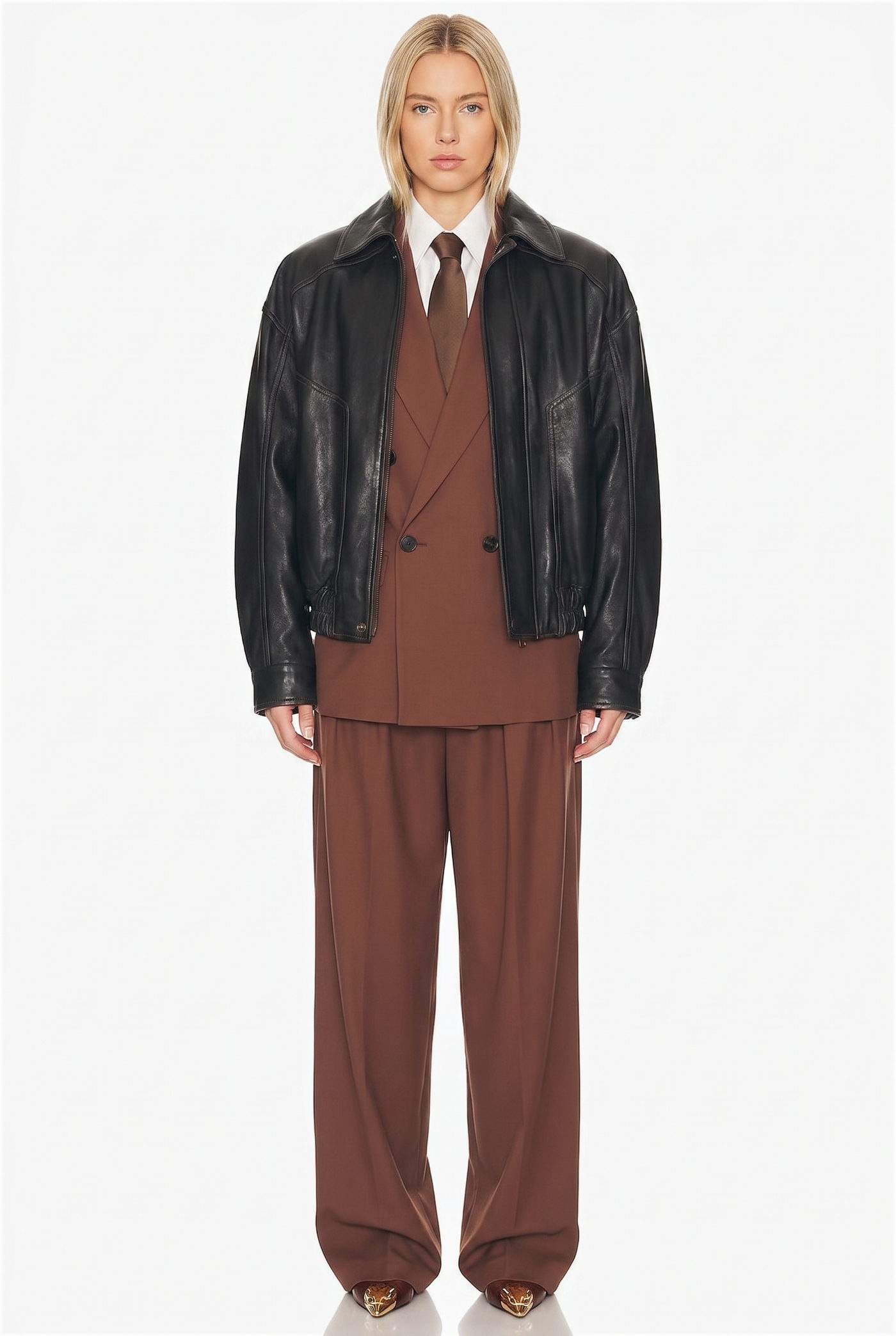 Woman in a black leather jacket over a brown suit with a tie